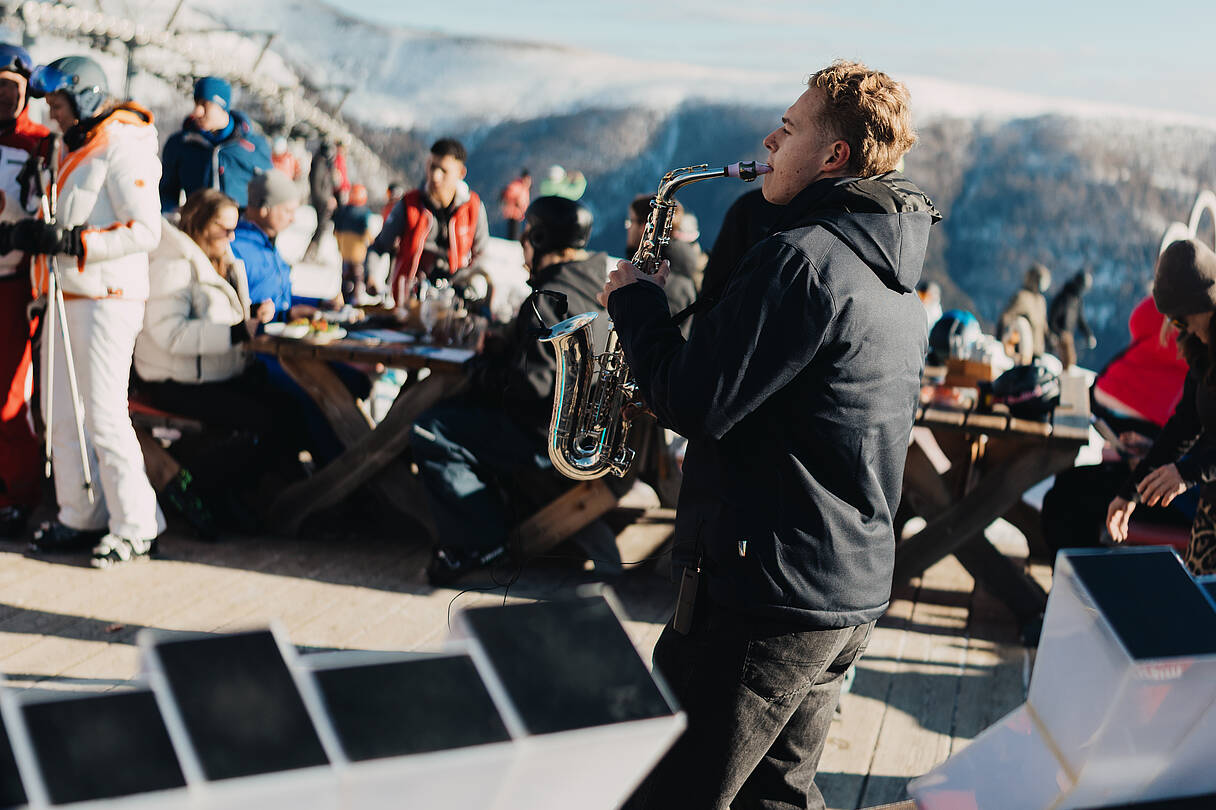 Mann mit Saxophon und Menschenmenge im Hintergrund beim Nock Beats Event